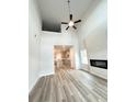 Bright living room with high ceilings, modern fireplace, and luxury vinyl plank flooring throughout at 123 Deer Xing, Temple, GA 30179