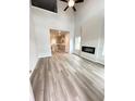 Bright living room with high ceilings, modern fireplace, and luxury vinyl plank flooring throughout at 123 Deer Xing, Temple, GA 30179
