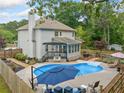 Backyard oasis with a sparkling pool, patio area, and lush greenery at 1482 Pinebark Ct., Grayson, GA 30017