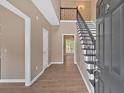 Bright foyer with high ceilings, wood floors, staircase, and open view to the home's interior at 5705 Cannonero Dr, Alpharetta, GA 30005
