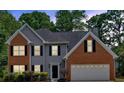 Charming two-story home featuring a brick and gray siding, with beautiful landscaping and a two-car garage at 5705 Cannonero Dr, Alpharetta, GA 30005