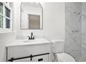 Renovated bathroom featuring a modern vanity, toilet, and tiled shower at 1780 Kinridge Rd, Marietta, GA 30062