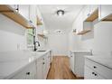 Modern kitchen with white cabinets, quartz countertops, and hardwood floors at 1780 Kinridge Rd, Marietta, GA 30062