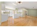 Bright kitchen with hardwood floors, white cabinetry, and modern appliances, perfect for cooking at 2620 Matlin Way, Buford, GA 30519