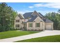 Beautiful brick home with a well-kept lawn, attached garage, and a driveway at 3298 Alcovy Club Ct, Dacula, GA 30019