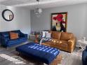 Well-lit living room featuring two leather sofas, an ottoman, and stylish decor at 5536 Strathmoor Manor Cir, Lithonia, GA 30058