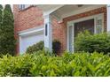 Close-up of a red brick home with an attached garage and inviting front entryway at 7812 Kiverton Pl, Atlanta, GA 30350