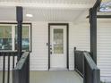 Inviting covered entryway boasting a white door with decorative glass and black trim at 117 Spring St, Stockbridge, GA 30281
