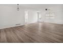 Spacious, open-concept living area featuring light-colored wood floors and neutral walls at 117 Spring St, Stockbridge, GA 30281