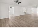 Bright, expansive living room with new light wood-look flooring, and fresh white paint at 117 Spring St, Stockbridge, GA 30281