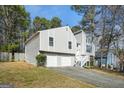 Charming two-story home with a two-car garage, complemented by a well-kept lawn and mature trees at 3813 Nowlin Nw Rd, Kennesaw, GA 30144