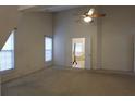 Neutral bedroom with carpet, a ceiling fan, and natural light from two windows at 442 John Stewart Pl, Suwanee, GA 30024