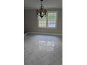 Dining room with tile flooring and a decorative chandelier at 1947 Kensington High Sw St, Lilburn, GA 30047