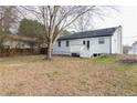 Spacious backyard featuring a small deck, grassy area and privacy fence at 2172 Red Rose Ln, Loganville, GA 30052