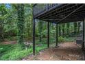 Backyard featuring a covered patio perfect for outdoor entertaining surrounded by mature trees at 336 Rockmoor Trl, Marietta, GA 30066