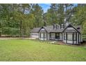 Charming two-story home with white siding, black trim, and a well-manicured front yard at 4902 Cedar Se Ct, Conyers, GA 30094