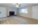 Cozy living room featuring a fireplace, hardwood floors, and natural light at 3436 Lake Monroe Rd, Douglasville, GA 30135