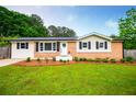Beautiful single-story home with brick accents, a welcoming entrance, and a lush green lawn at 4529 Lakeview Dr, Powder Springs, GA 30127