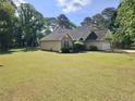 Ranch-style home with a well-maintained lawn, attractive landscaping, and attached two-car garage at 110 Orleans Blvd, Mcdonough, GA 30253