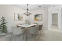 Bright dining area with a chandelier and stylish furniture, ideal for Gathering meals and gatherings at 1214 Lake Pointe Cir, Roswell, GA 30075