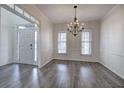 Formal dining room with hardwood floors, a decorative chandelier, and ample natural light at 233 Yorkshire Ln, Villa Rica, GA 30180