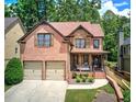 Charming two-story home with a brick and stone facade, a two-car garage, and a cozy front porch at 233 Yorkshire Ln, Villa Rica, GA 30180