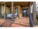 Inviting front porch featuring stone accents, hanging lights, and a cozy porch swing at 233 Yorkshire Ln, Villa Rica, GA 30180