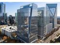 Modern high-rise building with glass facade reflects the surrounding cityscape offering premier city living at 3325 Piedmont Ne Rd # 3005, Atlanta, GA 30305