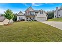 Beautiful two story home with a manicured lawn on a large lot with an attached two car garage at 4575 Birch Way, Loganville, GA 30052