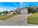 Two-story home featuring a manicured lawn, stone accents, and an attached two-car garage at 4575 Birch Way, Loganville, GA 30052