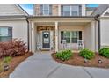 Inviting front porch with rocking chairs and manicured landscaping at 4575 Birch Way, Loganville, GA 30052