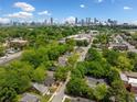 Scenic aerial view showing mature tree cover, residential homes and the Atlanta skyline in the background at 957 Harwell Nw St, Atlanta, GA 30314