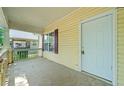 Covered porch featuring siding, window with shutters, and entry door of the home at 957 Harwell Nw St, Atlanta, GA 30314