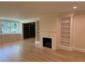 Cozy living room with fireplace, built-in bookshelves, and lots of natural light at 2734 Peachtree Nw Rd # B402, Atlanta, GA 30305
