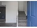 Welcoming entryway featuring carpeted stairs, with hardwood floors and modern accent wall at 4701 Flat Shoals Rd # 35E, Union City, GA 30291