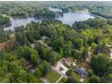 Aerial view of a neighborhood on a lake, showing home and surrounding trees and a pool at 522 Knollwood Dr, Stockbridge, GA 30281