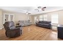 Open-concept living room features hardwood floors, ceiling fans, and neutral paint at 522 Knollwood Dr, Stockbridge, GA 30281