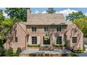 Elegant brick home with a symmetrical facade and black trimmed windows offers timeless appeal at 2515 Habersham Rd, Atlanta, GA 30305