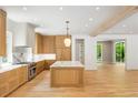 Well-lit kitchen showcases an island, marble backsplash, and stainless steel appliances with hardwood flooring at 2515 Habersham Rd, Atlanta, GA 30305