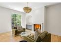 Cozy living room with fireplace, stylish light fixture, wet bar and a sun-drenched window at 2515 Habersham Rd, Atlanta, GA 30305