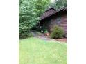 Cozy home featuring lush green landscaping and a brick pathway leading to the entrance at 3315 Canterbury Trl, Rex, GA 30273