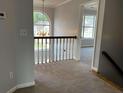 Upstairs hallway with carpet, chandelier, and lots of light at 500 Kings Pl, Riverdale, GA 30296