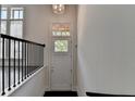 Inviting foyer featuring a light-filled doorway and elegant railing at 614 Harrington Hls, Decatur, GA 30032