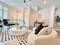 Bright living room with stylish furniture, dark wood floors, and staircase at 614 Harrington Hls, Decatur, GA 30032
