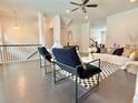 Open concept living area featuring dark wood floors and wrought iron railing at 614 Harrington Hls, Decatur, GA 30032