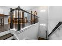 Inviting entryway with hardwood stairs, a white front door, and a view to the dining area at 1098 Caruso Dr, Buford, GA 30518