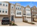 Charming multi-story townhouse showcasing brick and siding details, plus convenient garage access at 1098 Caruso Dr, Buford, GA 30518