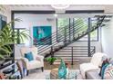 Bright living room featuring a modern staircase, hardwood floors, and contemporary decor at 240 Patterson Se Ave, Atlanta, GA 30316
