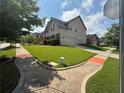 A well-maintained lawn surrounds this suburban home with a paved driveway and sidewalks at 4316 Kershaw Dr, Snellville, GA 30039