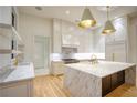 Gourmet kitchen features marble countertops, custom cabinets, and pendant lighting at 4550 Jolyn Pl, Sandy Springs, GA 30342